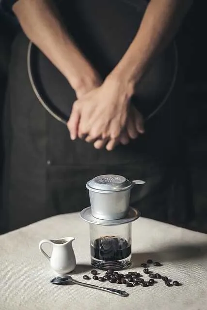 Espresso w małym kubku na tle ziaren kawy – intensywny smak i aromat